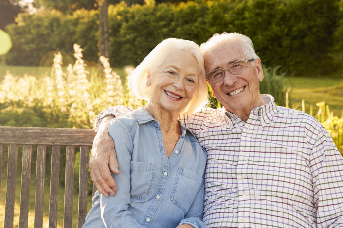 Senior Couple Sitting On Garden Bench In Evening Sunlight Couples Counseling at Center for Relationship Wellness